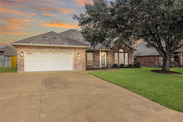 view of front facade featuring a garage and a lawn