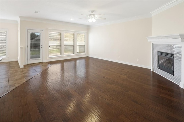 unfurnished living room with ceiling fan, a brick fireplace, and ornamental molding