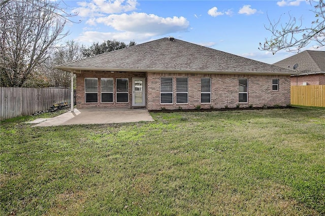 back of house featuring a patio and a yard