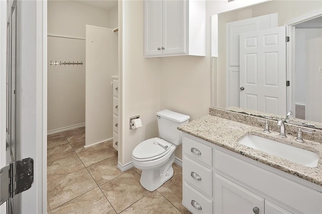 bathroom featuring tile patterned flooring, vanity, and toilet