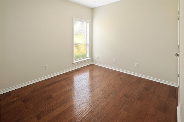 empty room featuring dark hardwood / wood-style flooring and a wealth of natural light