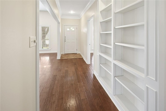 interior space featuring dark wood-type flooring, built in features, and crown molding