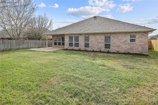 rear view of property featuring a patio area and a yard