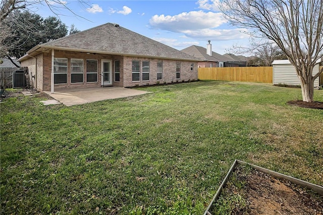 exterior space featuring a lawn, cooling unit, a patio area, and a shed