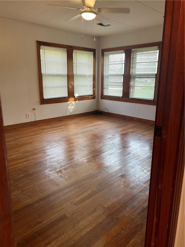 unfurnished room with ceiling fan and hardwood / wood-style flooring