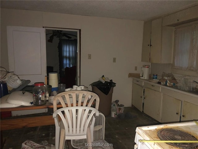 kitchen with a textured ceiling and ceiling fan