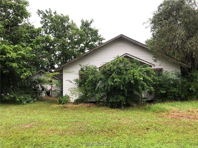 view of home's exterior featuring a yard