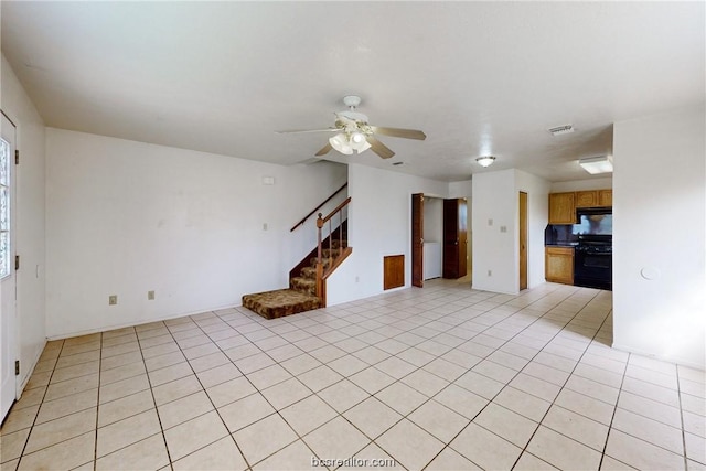 unfurnished living room featuring ceiling fan and light tile patterned flooring