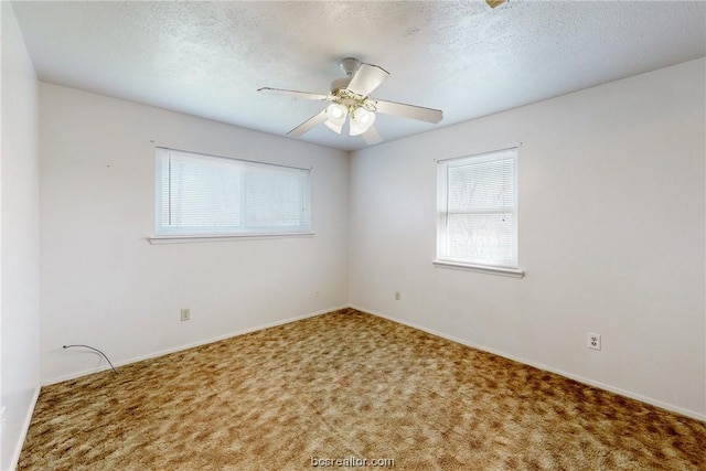 carpeted empty room with a textured ceiling and ceiling fan