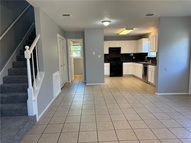 kitchen with white cabinets, stainless steel dishwasher, black / electric stove, decorative backsplash, and light tile patterned flooring