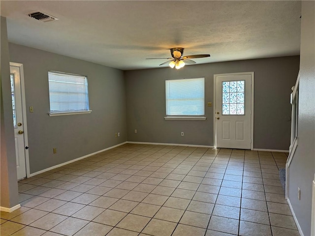 entrance foyer featuring ceiling fan and light tile patterned flooring