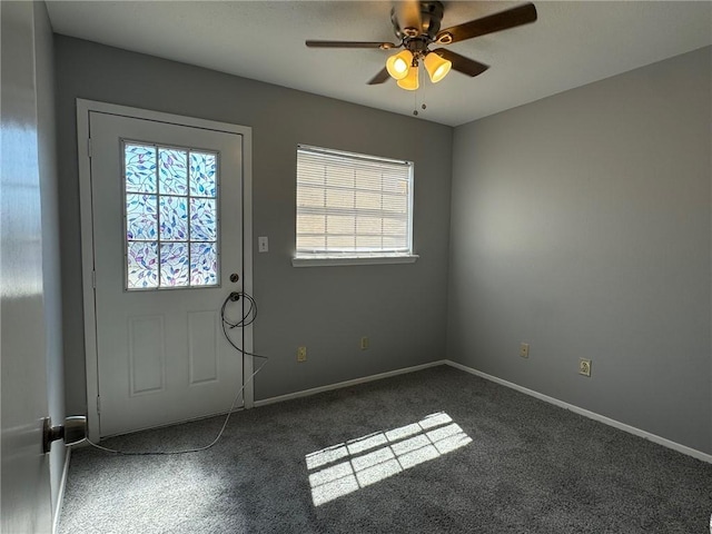 carpeted foyer entrance with ceiling fan