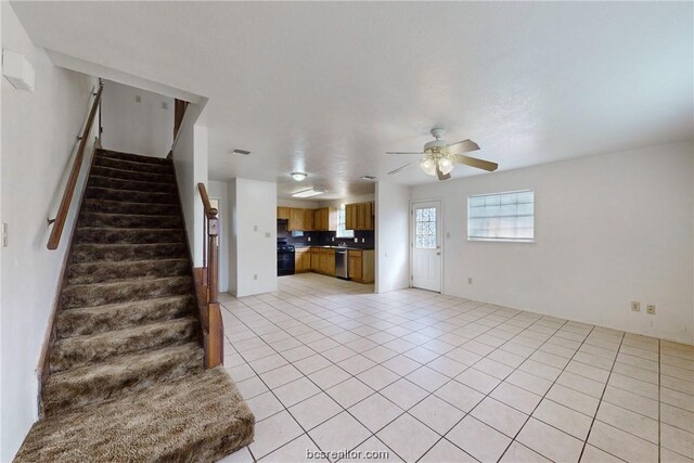 unfurnished living room featuring ceiling fan and light tile patterned floors