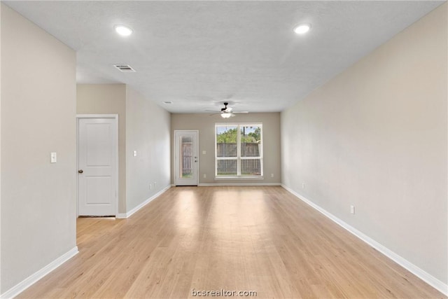 empty room featuring ceiling fan and light hardwood / wood-style flooring