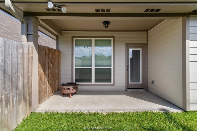 view of exterior entry featuring a patio area