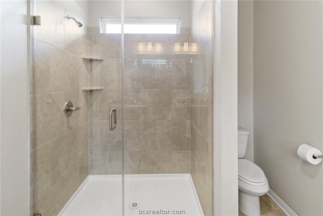 bathroom with toilet and a shower with door