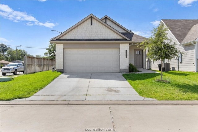 view of front facade with a front lawn, central AC unit, and a garage