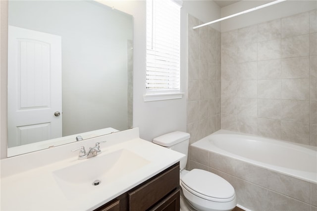 996 Marquis Dr, Bryan, TX 77803 - bathroom featuring toilet, vanity, and tiled shower / bath combo