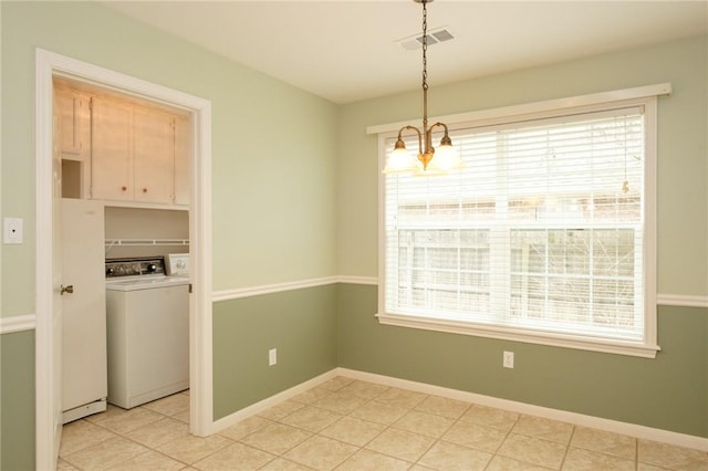 interior space with cabinets, separate washer and dryer, a healthy amount of sunlight, and an inviting chandelier