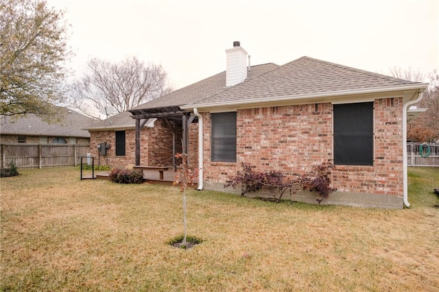 back of house featuring a lawn