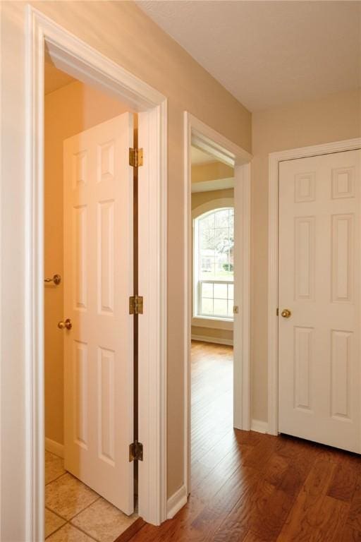 corridor with hardwood / wood-style floors