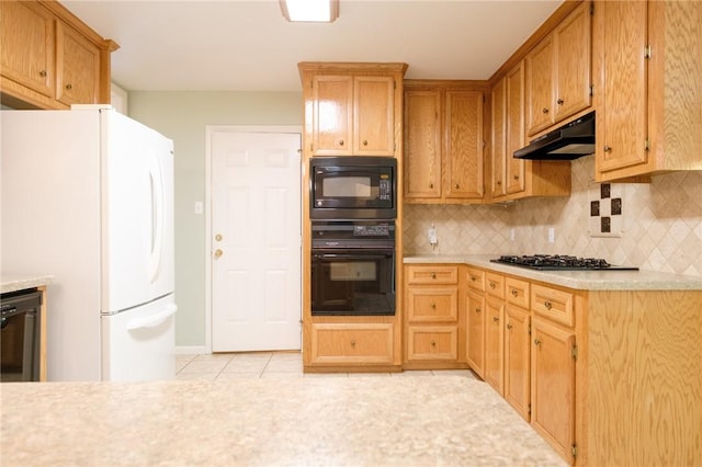 kitchen with tasteful backsplash, light tile patterned floors, and black appliances