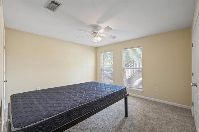 1725 Harvey Mitchell Pkwy, College Station, TX 77840 - carpeted bedroom with baseboards and a ceiling fan