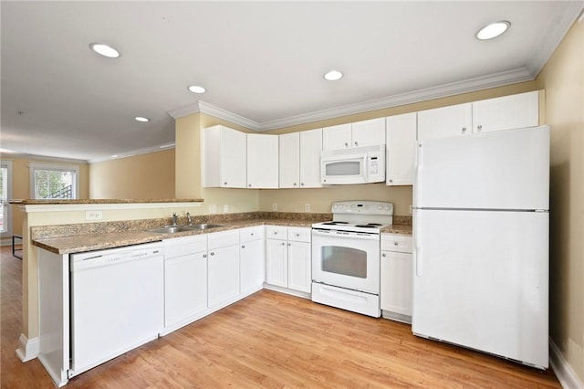 1725 Harvey Mitchell Pkwy, College Station, TX 77840 - kitchen with white appliances, ornamental molding, a sink, white cabinetry, and a peninsula