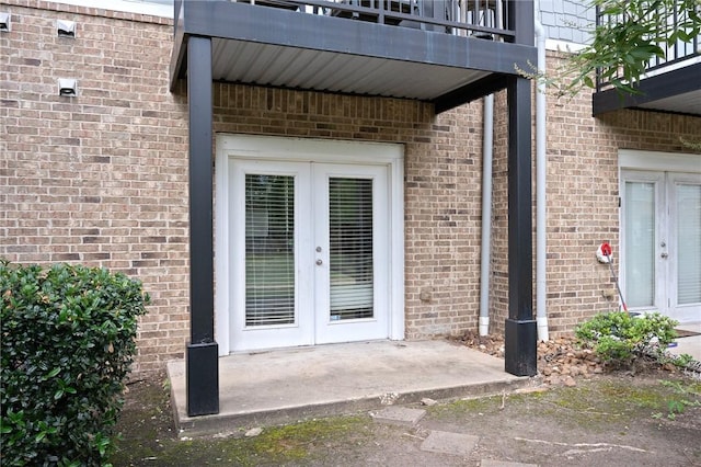 1725 Harvey Mitchell Pkwy, College Station, TX 77840 - doorway to property featuring french doors, brick siding, and a balcony