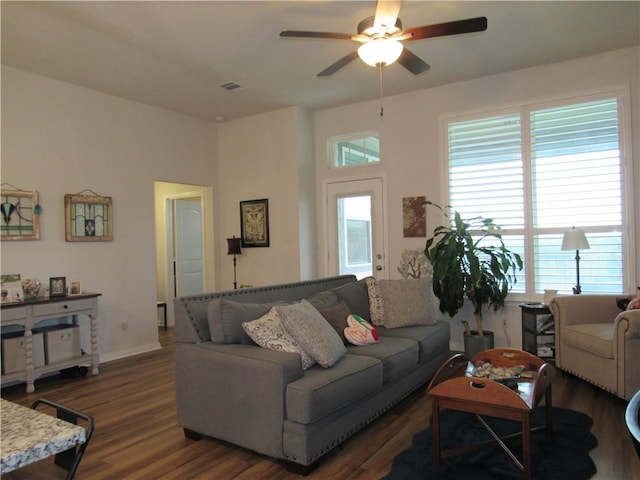 living room featuring plenty of natural light, a ceiling fan, and wood finished floors