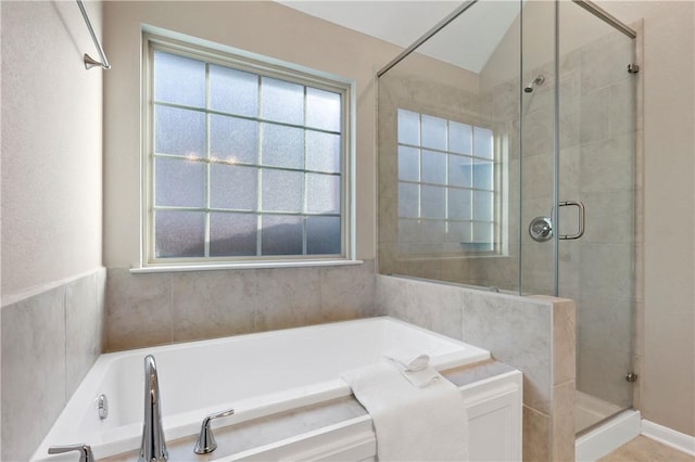 bathroom with separate shower and tub