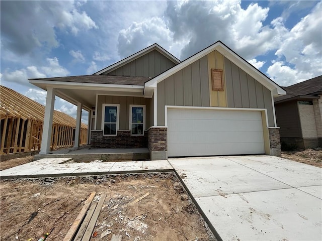 view of front of property featuring covered porch and a garage