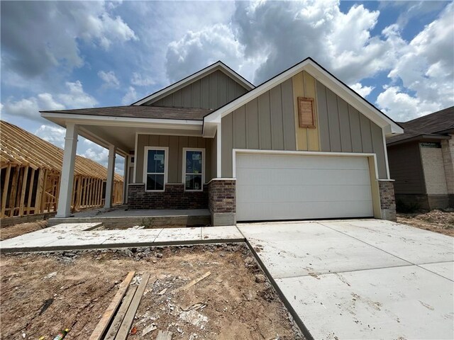 view of front of property featuring covered porch and a garage