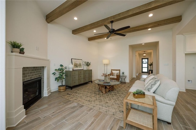 living room with beamed ceiling, light wood finished floors, and recessed lighting