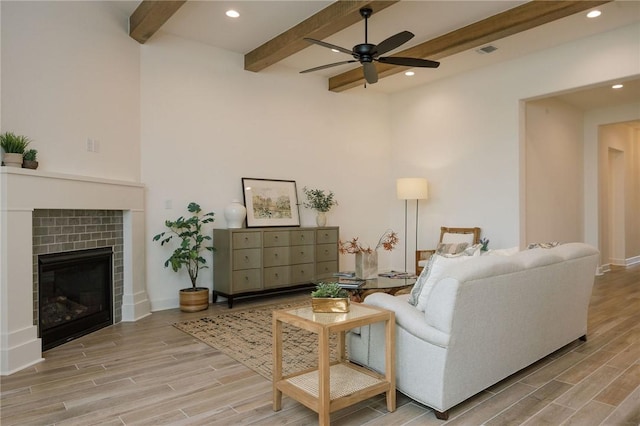 living room with beam ceiling, ceiling fan, light wood-type flooring, and recessed lighting