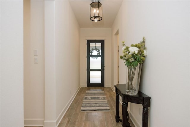 entryway with baseboards and light wood-style floors