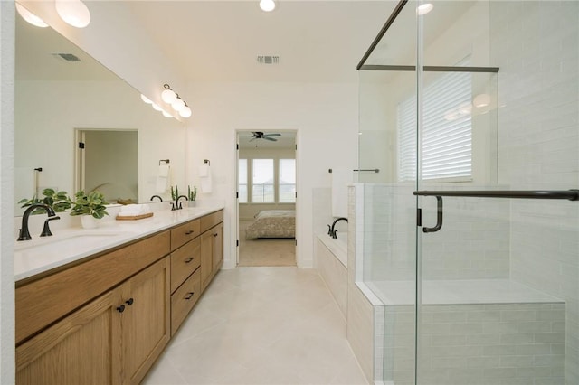 ensuite bathroom with visible vents, a shower stall, ensuite bath, and a sink