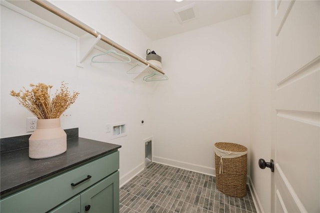 washroom featuring washer hookup, electric dryer hookup, visible vents, baseboards, and cabinet space