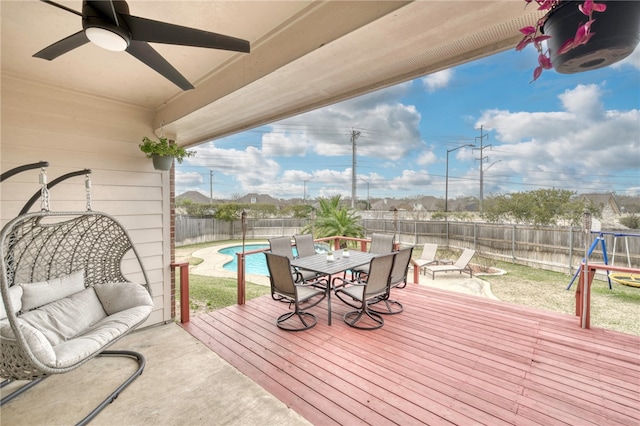 wooden terrace with a fenced in pool, a trampoline, and a patio area