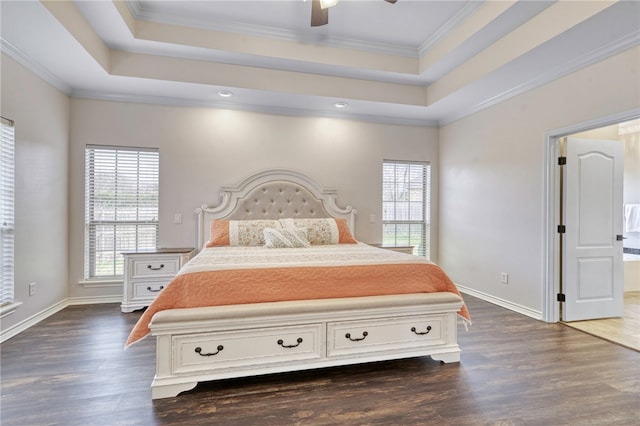 bedroom with crown molding, ceiling fan, a tray ceiling, and dark hardwood / wood-style flooring