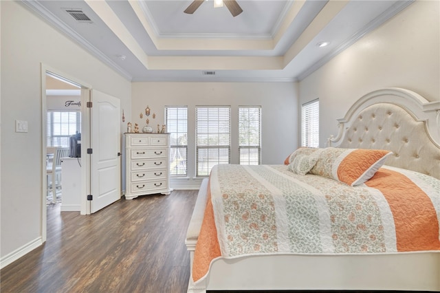 bedroom featuring ceiling fan, ornamental molding, dark hardwood / wood-style flooring, and a raised ceiling