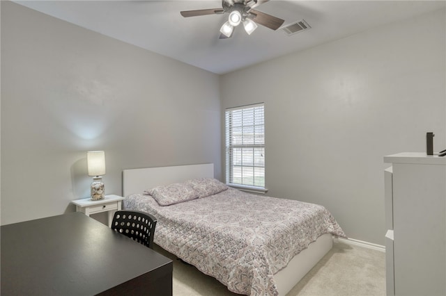 bedroom with ceiling fan and light carpet