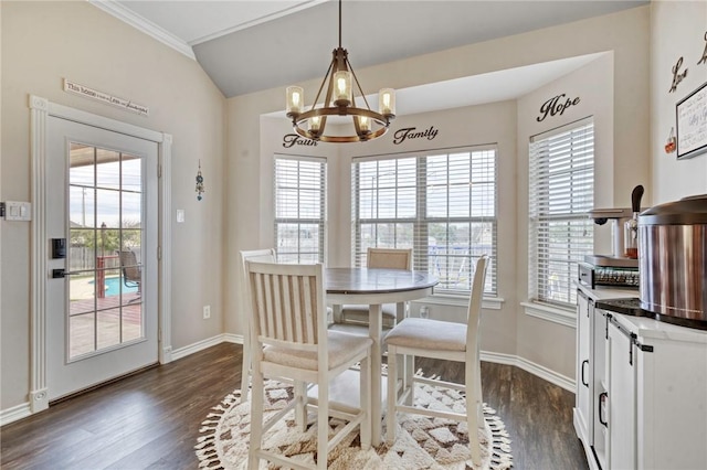 dining area featuring ornamental molding, a notable chandelier, and dark hardwood / wood-style flooring