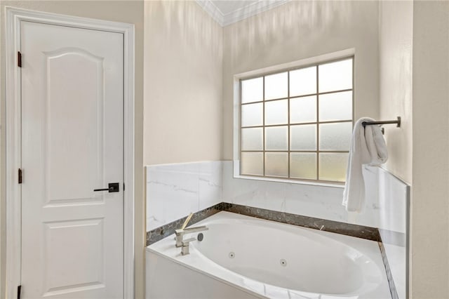 bathroom featuring ornamental molding and a bathtub