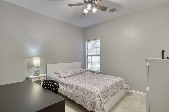 bedroom with visible vents, a ceiling fan, baseboards, and light carpet