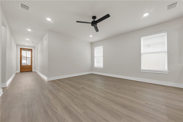 empty room with ceiling fan and light wood-type flooring