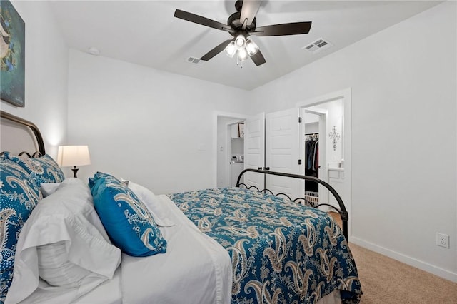 bedroom featuring ceiling fan, a walk in closet, carpet floors, and a closet