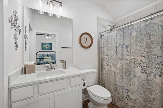 bathroom featuring curtained shower, vanity, lofted ceiling, and toilet