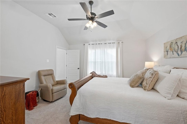 carpeted bedroom with ceiling fan and vaulted ceiling