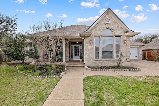 view of front of home with a garage, a front lawn, concrete driveway, and brick siding